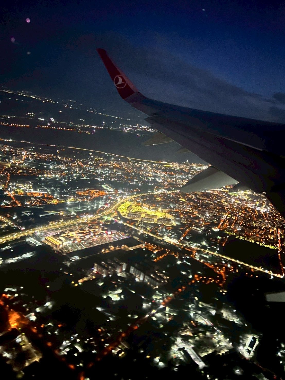 トルコ航空の機内の窓から見た夜景と翼